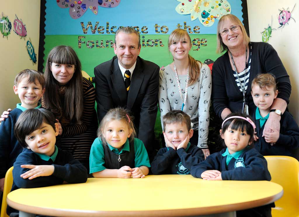Richard White, headteacher at St Paul's Primary with early years staff and pupils