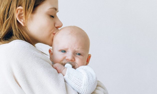 woman comforting a baby