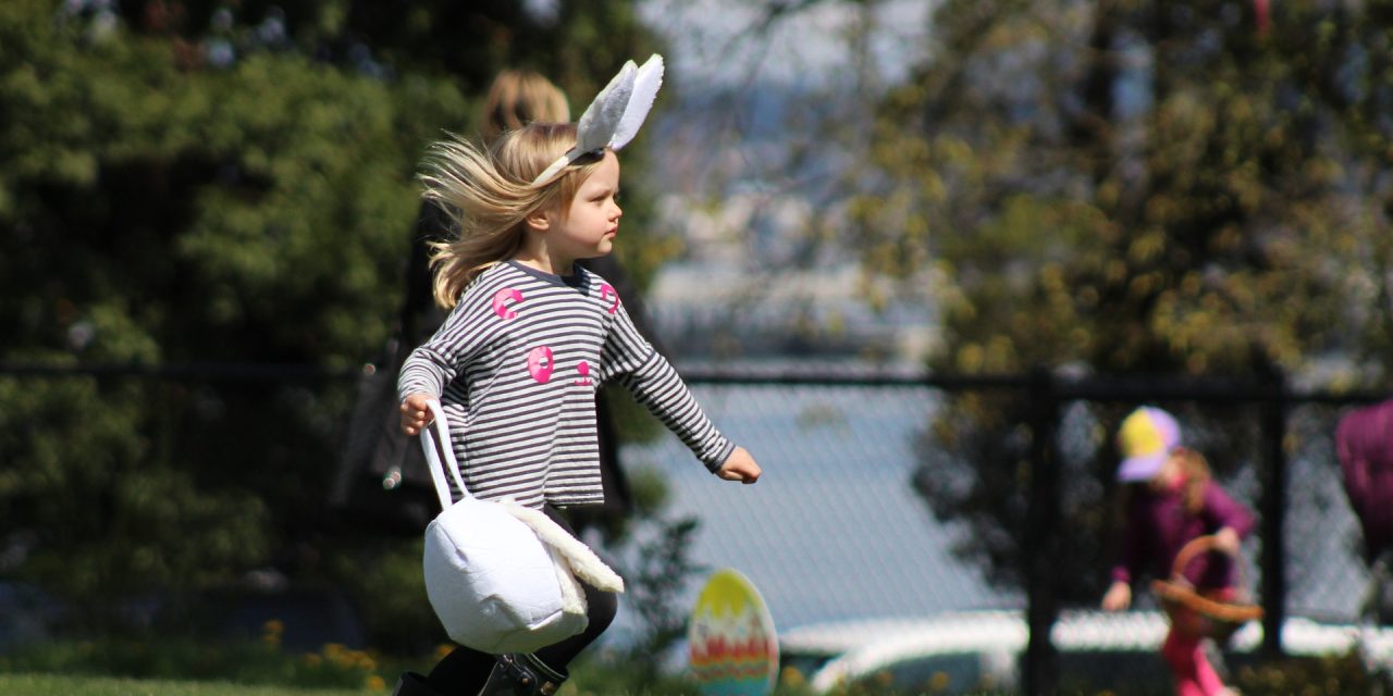 Young girl wearing bunny ears playing Easter games