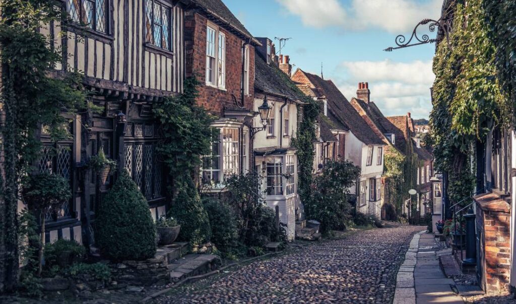 A cobbled street Rye, in East Sussex with Edwardian buildings running down each side. The image confirms Rye is one of the most romantic spots in East Sussex.