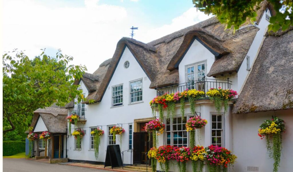 A pretty white pub with a thatched roof in East Sussex.