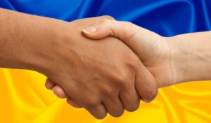 Handshake in front of a Ukraine flag