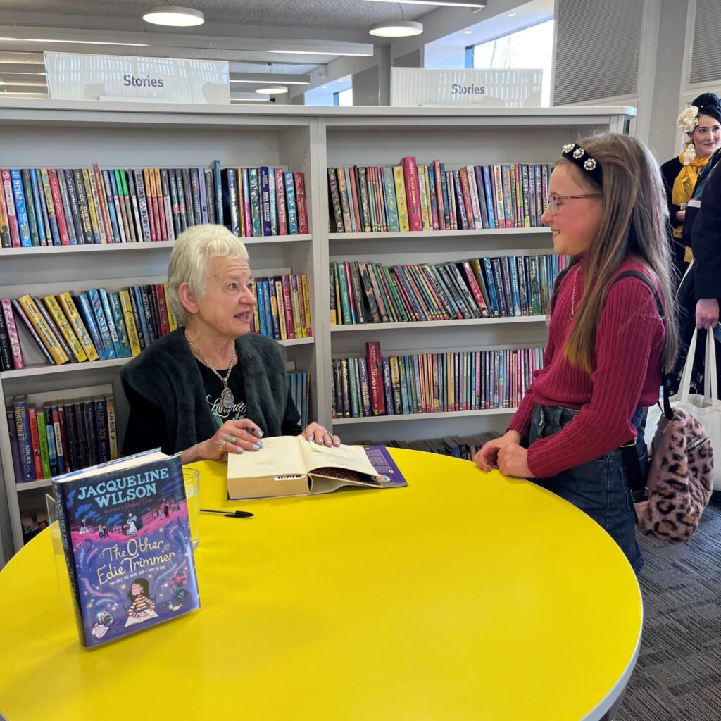 Jacqueline Wilson signing her new book for young girl