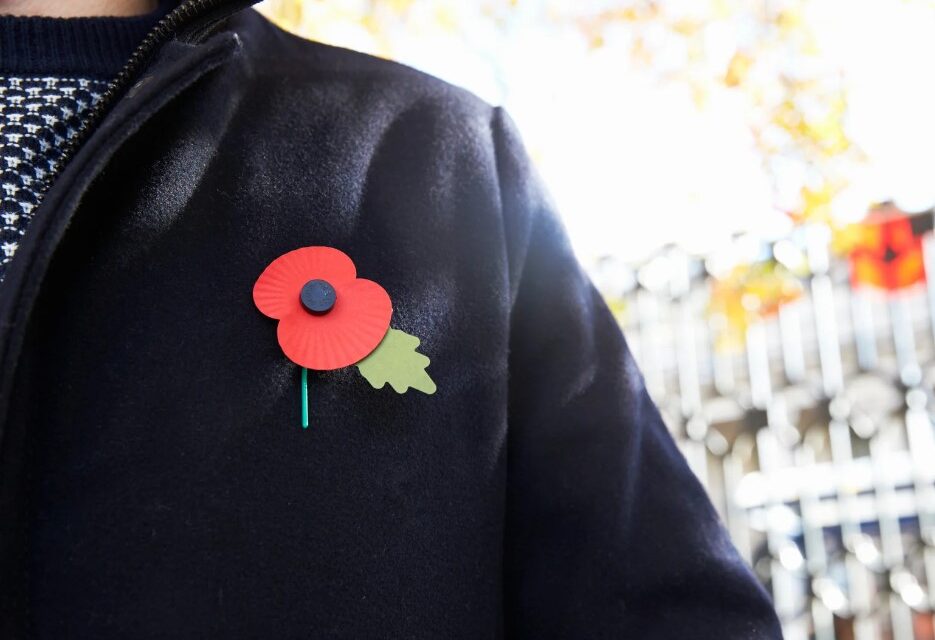 Remembrance Day poppy pinned to jacket.