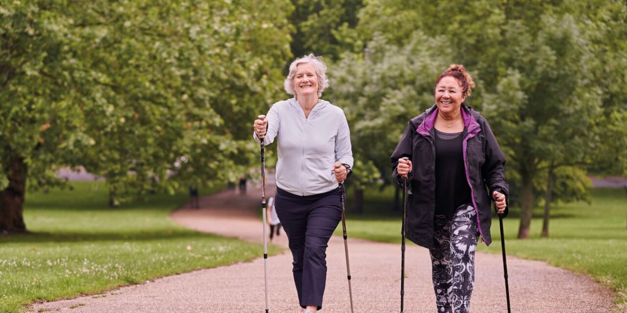 two woman walking in a park as part of their active lifestyle