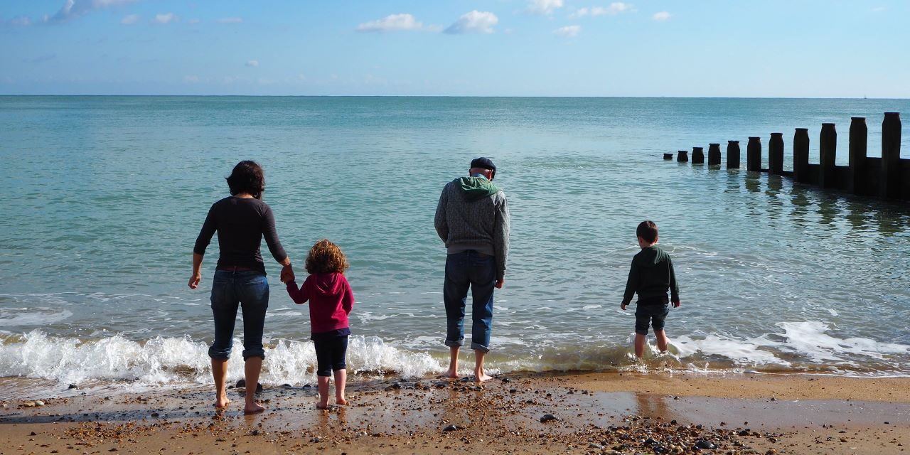 a family paddling in the sea