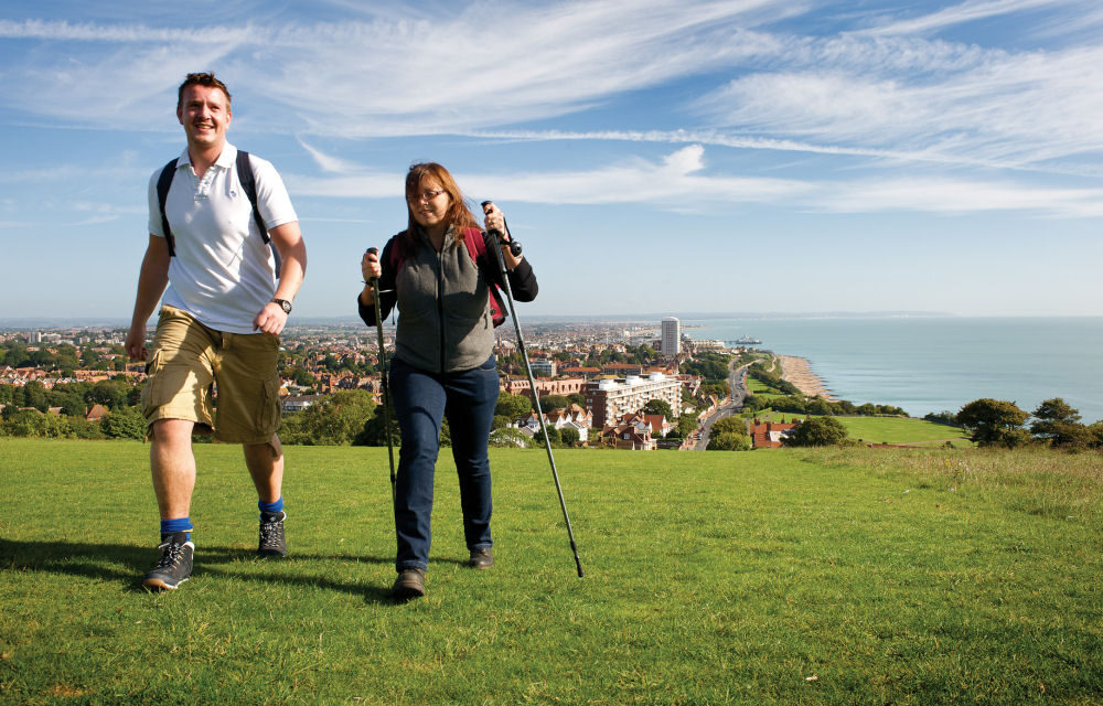 a man and a woman walking on the Downs above Eastbourne