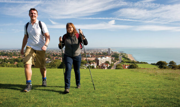 a man and a woman walking on the Downs above Eastbourne