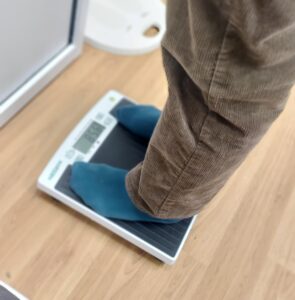 person stands on a weighing scale