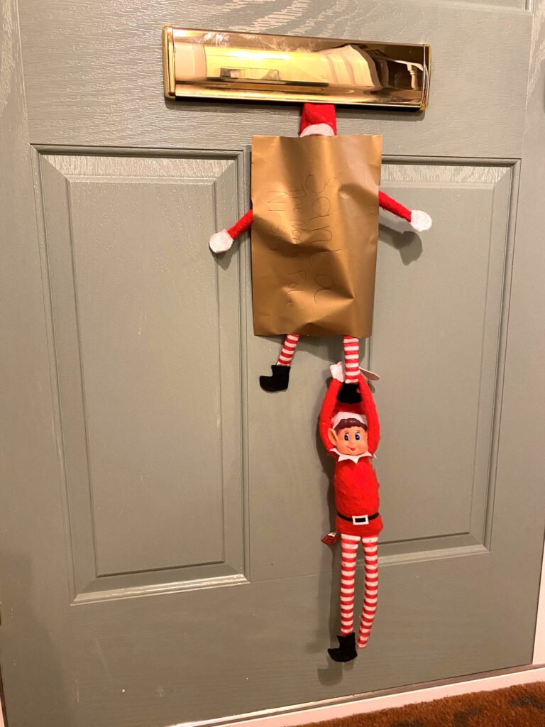 Elf on the Shelf hanging out the letterbox