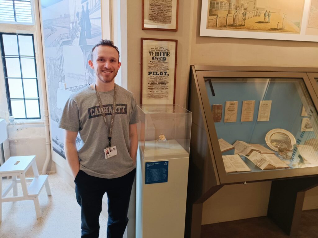 Jack Guy, Hastings Museum curator and member of In-sight, in Hastings Museum & Art Gallery, standing next to museum displays.