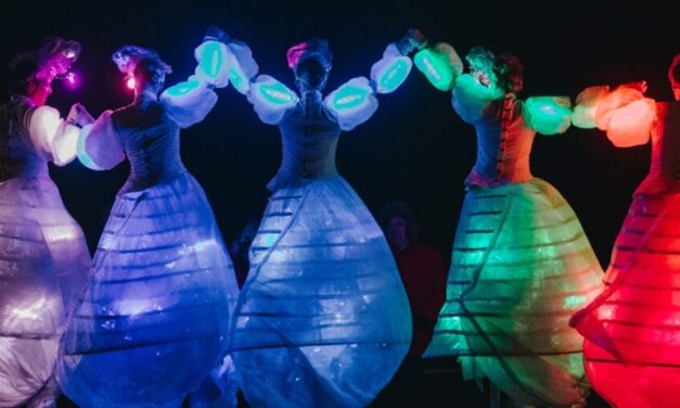 ladies dancing in coloured illuminated dresses