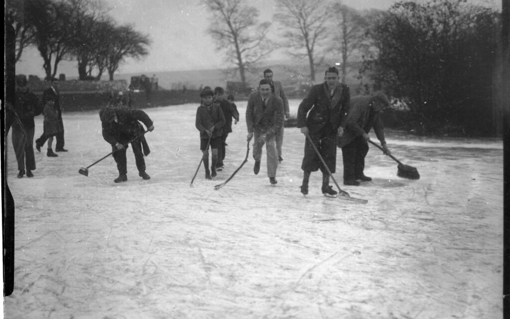 People skating on a frozen Falmer pondin East Sussex