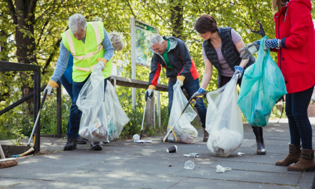 A group on a path surrounding by trees litter pick in East Sussex