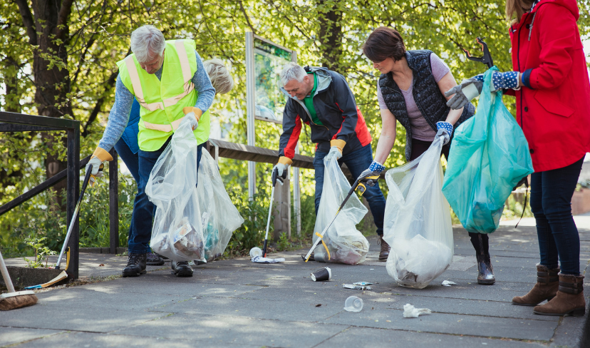 A group on a path surrounding by trees litter pick in East Sussex