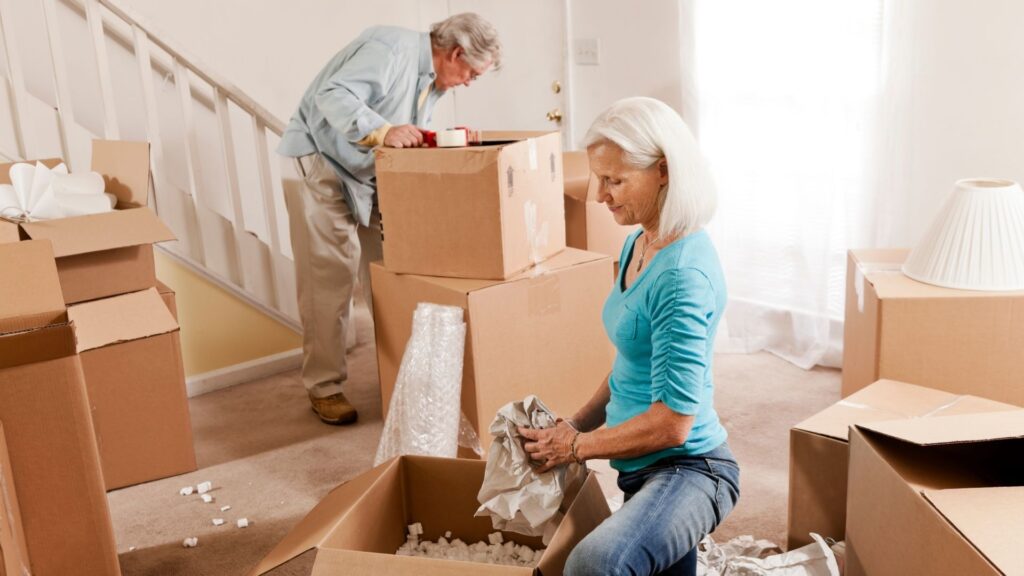 A woman and a man packing brown boxes