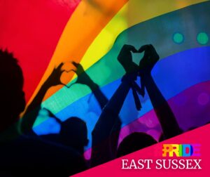 shiloutte hands make heart shapes in front of bright rainbow colours