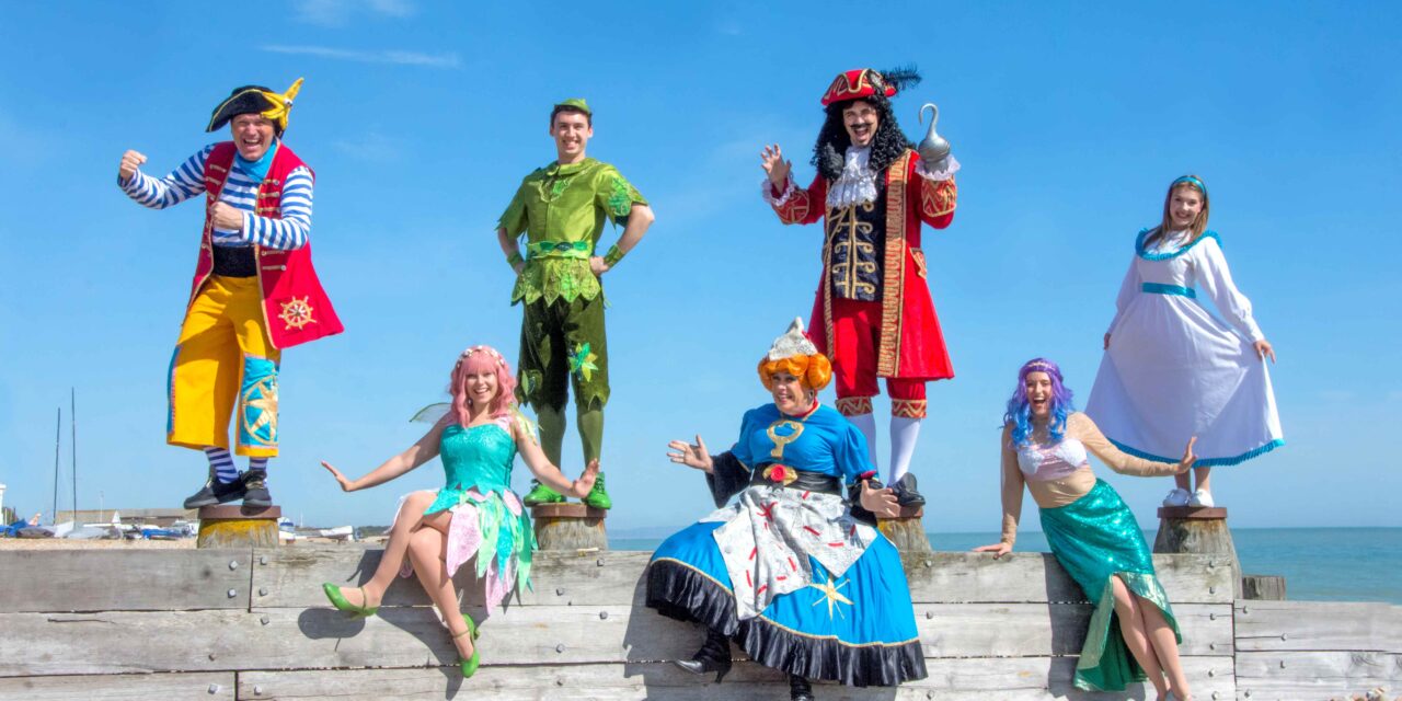 Peter Pan characters on the beach on a sunny day