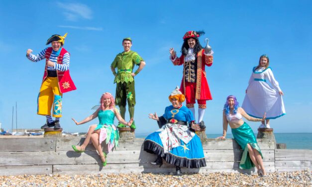 Peter Pan characters on the beach on a sunny day
